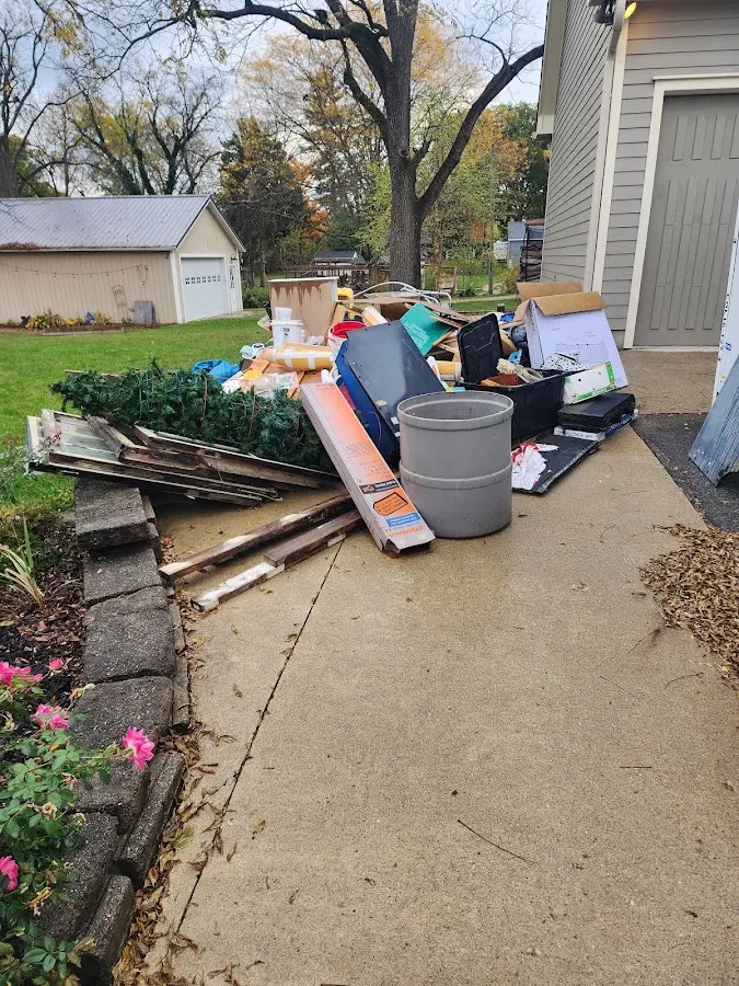 Dumpster being loaded with debris for Estate Cleanout Dumpster Rental in Montrose-Ghent